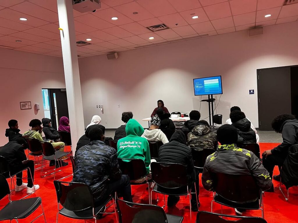 People seated watching a presentation on a screen.