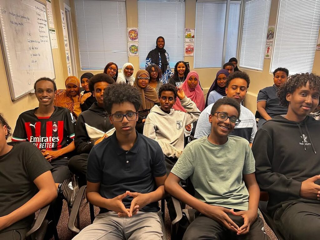 A group of people seated together during an indoor session.
