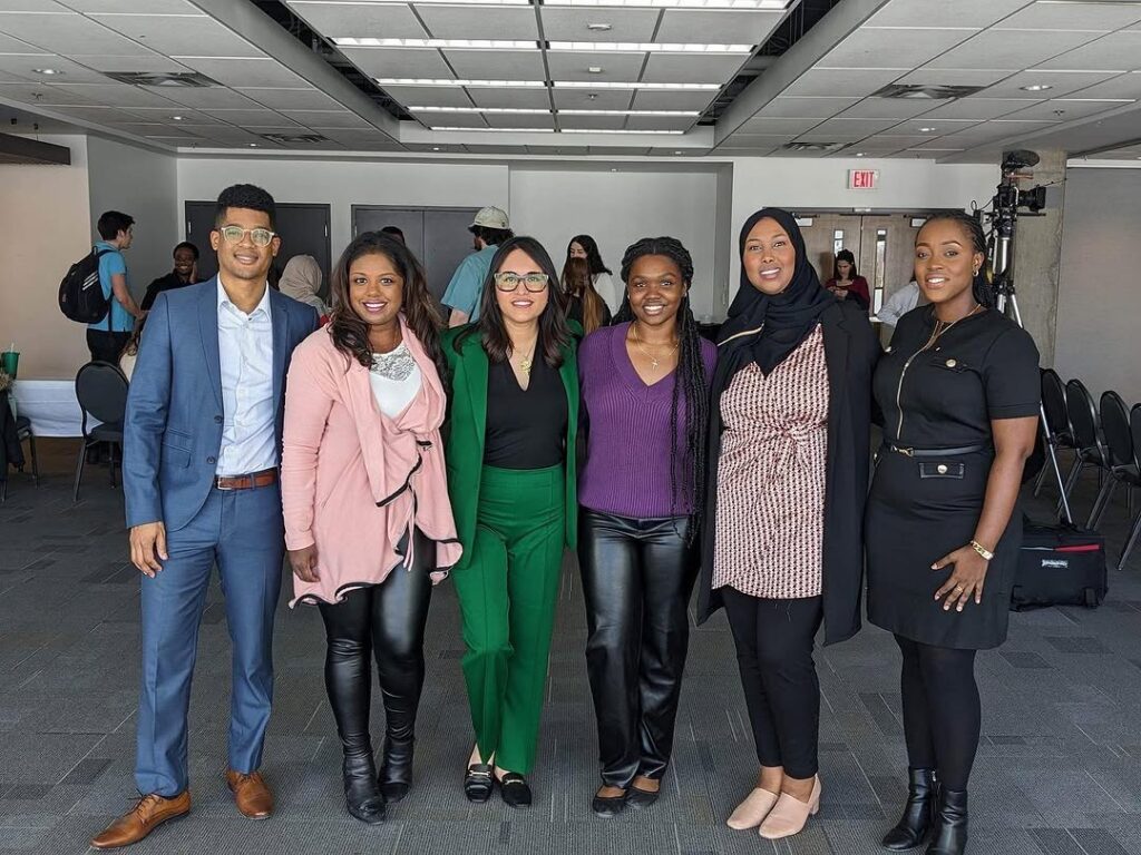 A group of people standing together for a photo at an indoor event.