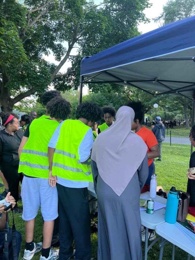 People wearing high-visibility vests at an outdoor event.