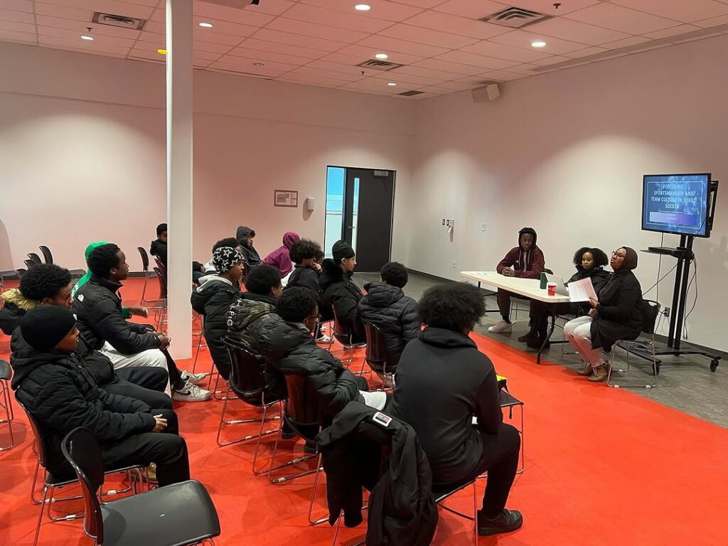 A group of young people standing together indoors.